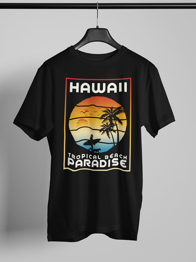 A black t-shirt with a colorful Hawaii themed print featuring a sunset, palm trees, and a surfer, hanging against a white background.