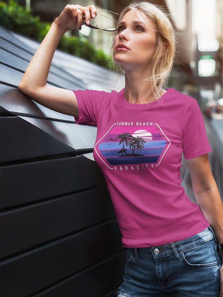 A person leans against a dark panel surface, wearing a pink t-shirt with "Summer Beach Paradise" print, blue jeans, looking upwards pensively with sunglasses in hand.