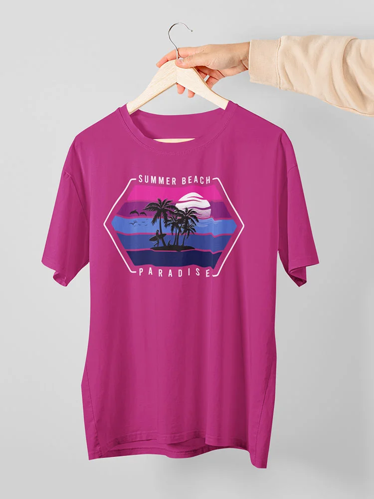 A person's hand is holding a wooden hanger with a magenta t-shirt featuring a tropical beach design and the words "Summer Beach Paradise."