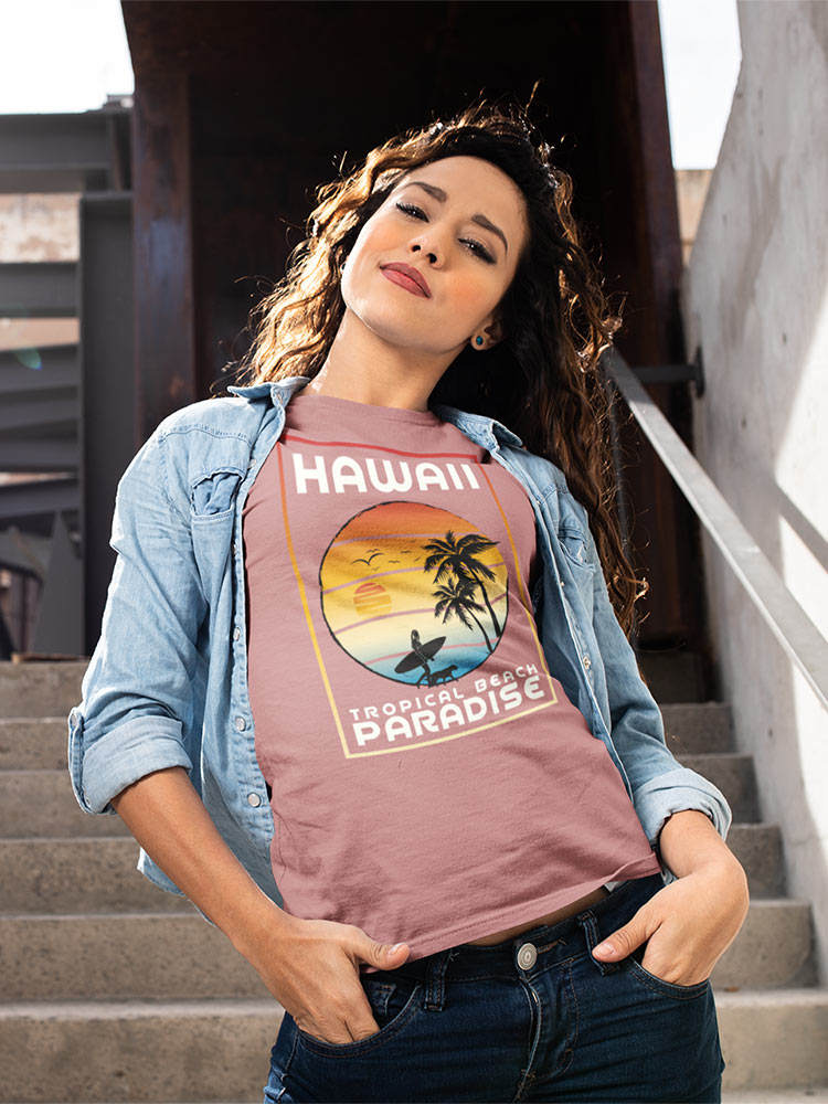 A person stands on stairs wearing a denim jacket over a Hawaii-themed T-shirt. They're casually posing with a hand on the hip, exuding confidence.