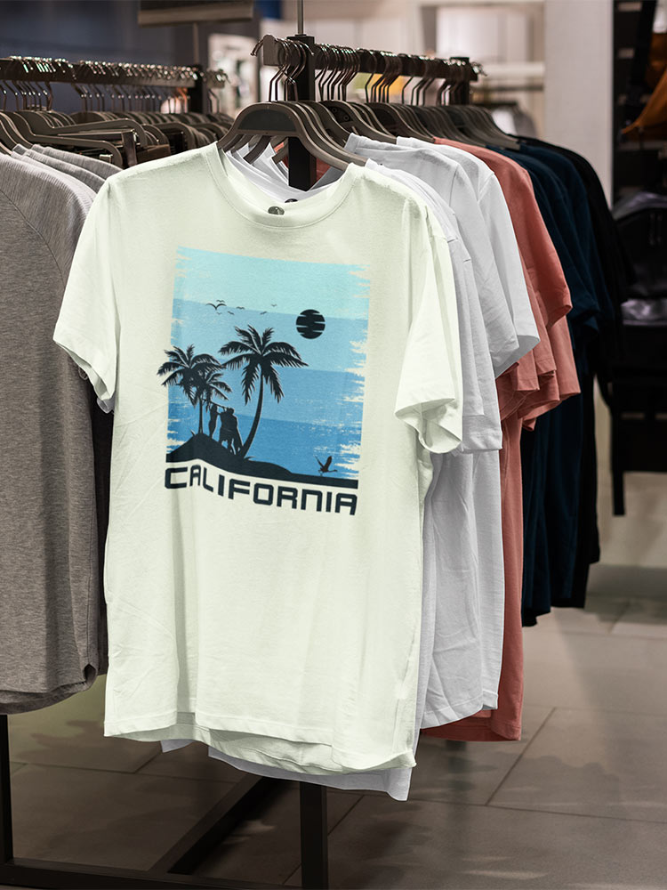 A selection of t-shirts on display in a clothing store featuring various colors, with a prominent California-themed print on the front shirt.