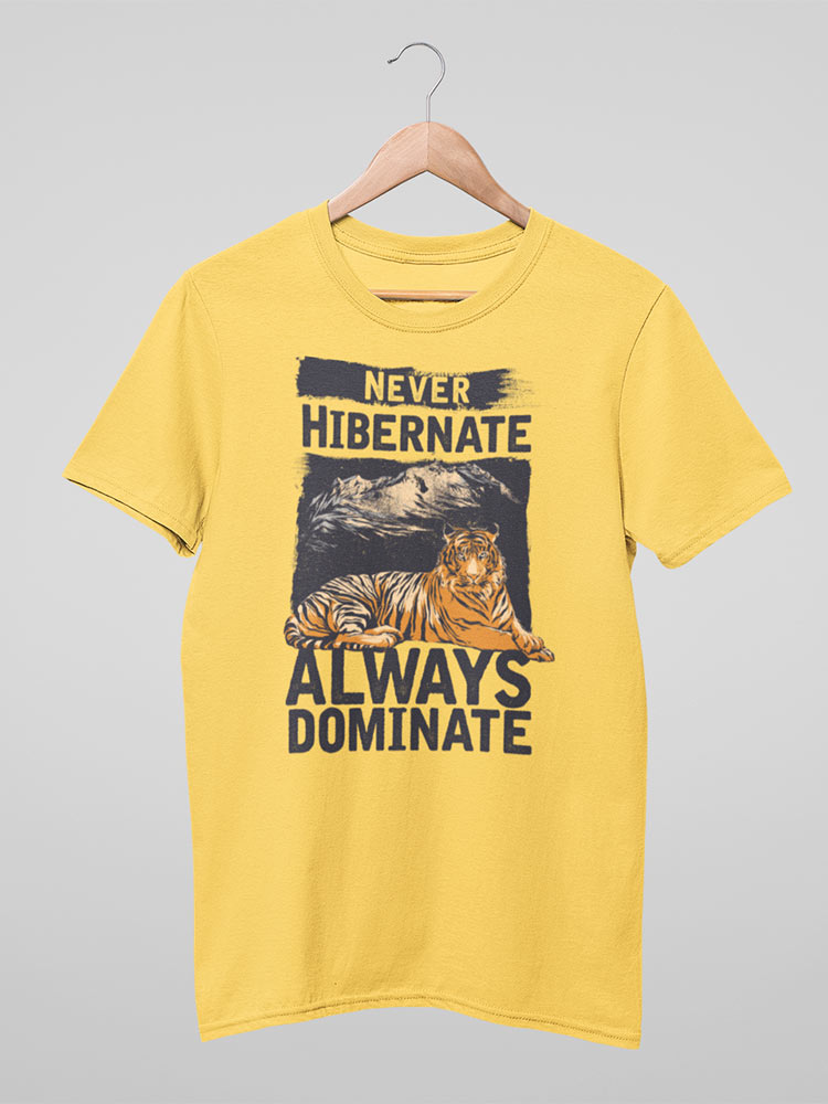 A yellow T-shirt on a hanger features a printed graphic of a tiger and the text "NEVER HIBERNATE ALWAYS DOMINATE" in bold, capital letters.