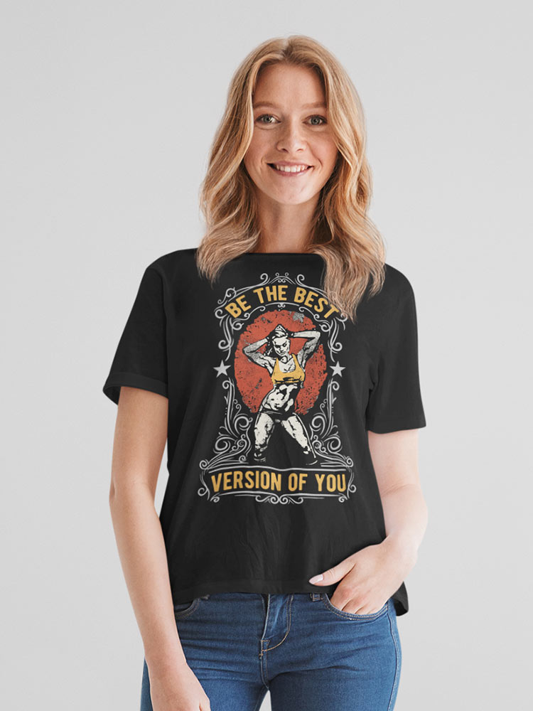 A person is smiling and wearing a black t-shirt with an inspirational message "Be The Best Version Of You" surrounding a graphic design.